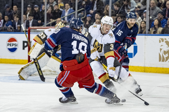 New York Rangers center Vincent Trocheck and left wing Artemi Panarin (10) vie for the puck against Vegas Golden Knights defenseman Brayden McNabb (3) during the first period Friday, Jan. 26, 2024, in New York. 

