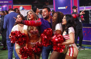 Gustavo Ambriz, a journalist with NFL Mexico, poses with San Francisco 49ers cheerleaders during Super Bowl LVIII Opening Night at Allegiant Stadium Monday, Feb. 5, 2024.