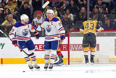 Edmonton Oilers center Connor McDavid (97) celebrates with Edmonton Oilers center Leon Draisaitl (29) after his goal against the Vegas Golden Knights during the first period of an NHL hockey game at T-Mobile Arena Tuesday, Feb. 6, 2024. Vegas Golden Knights center Paul Cotter (43) leans on the goal at right.