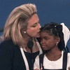 AIDS activist Mary Fisher kisses 12-year-old Hydeia Broadbent, a youngster who also has AIDS as they were both addressing the evening session of the 1996 GOP convention in San Diego Monday, Aug. 12, 1996. Broadbent, a prominent HIV/AIDS activist known for her inspirational talks in the 1990s as a young child to reduce the stigma surrounding the virus she was born with, has died. She was 39.