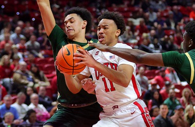 UNLV Rebels guard D.J. Thomas (11) is fouled as he drives to the basket between Colorado State Rams guards Jalen Lake (15) and Isaiah Stevens (4) during the first half of an NCAA basketball game at the Thomas & Mack Center Saturday, Feb. 24, 2024.