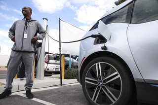 James Jackson charges his electric vehicle Thursday, Feb. 29, 2024 during a press conference held to ask the EPA and the Biden Administration to implement the strongest possible version of new light and medium vehicle emissions standards that go into effect in 2027.