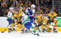 Vancouver Canucks defenseman Quinn Hughes (43) scores against Vegas Golden Knights goaltender Adin Hill (33) during the first period of an NHL hockey game at ...