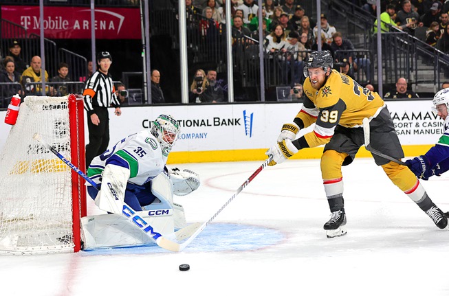 Vegas Golden Knights right wing Anthony Mantha (39) chases the puck in front of Vancouver Canucks goaltender Thatcher Demko (35) during the first period of an NHL hockey game at T-Mobile Arena Thursday, March 7, 2024.