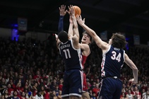 Saint Mary’s guard Aidan Mahaney, center, shoots while defended by Gonzaga guard Nolan Hickman (11) and forward Braden Huff (34) during the first half of ...