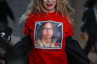 Jill Hough shows her shirt to the media Thursday, March, 14, 2024, at the Regional Justice Center, downtown, after a hearing of four juveniles accused in the death of Jonathan Lewis, 17, who died on Nov. 7, 2023, almost a week after a group of classmates beat him near Rancho High School.