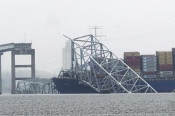 A container ship rests against the wreckage of the Francis Scott Key Bridge on Thursday, March 28, 2024, in Baltimore, Md. After days of searching through murky water for the workers missing after the bridge collapsed, officials are turning their attention Thursday to what promises to be a massive salvage operation.

