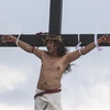 Ruben Enaje remains on the cross during the reenactment of Jesus Christ's sufferings as part of Good Friday rituals in San Pedro Cutud, north of Manila, Philippines, Friday, March 29, 2024.