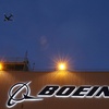 An airplane flies over a sign on Boeing's 737 delivery center, Oct. 19, 2015, at Boeing Field in Seattle. Boeing will be in the spotlight during back-to-back hearings Wednesday, April 17, 2024, as Congress examines allegations of major safety failures at the embattled aircraft manufacturer. 


