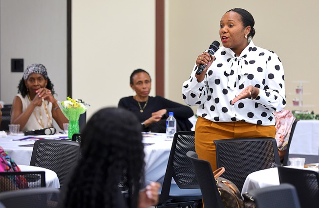 Joi Holliday-Sparrow talks about her experience conceiving a child through IVF during a Black Maternal Health Panel Discussion at the Doolittle Senior Center Wednesday, April 17, 2024. The event was part of Black Maternal Health Week and promoted by the Biden-Harris campaign.