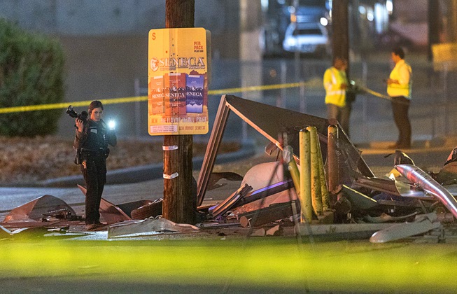 A Metro Police crime scene analyst takes photos at a fatal accident scene on southbound Boulder Highway Wednesday, April 17, 2024. An adult and child were killed and three others were injured, police said.