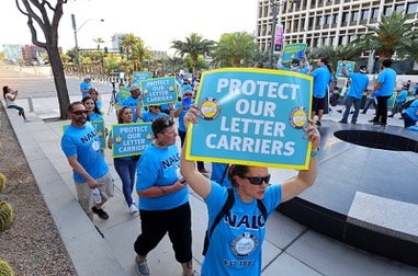 Letter carriers demonstrate in front of the Lloyd George Federal Building in downtown Las Vegas Wednesday, April 17, 2024. The demonstration was organized by the National Association of Letter Carriers, the national labor union of city delivery letter carriers employed by the United States Postal Service.
