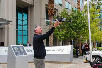 Gregory Stevens, Metro Detective, reaches out to grab the drone after a demonstration flight at the LVMPD Headquarters in Las Vegas, Nevada on Thursday, April 18, 2024.