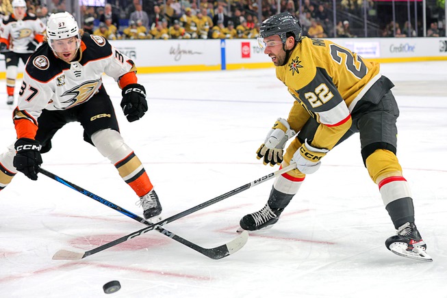 Anaheim Ducks defenseman William Lagesson (37) and Vegas Golden Knights right wing Michael Amadio (22) fight for the puck during the first period of an NHL hockey game at T-Mobile Arena Thursday, April 18, 2024.
