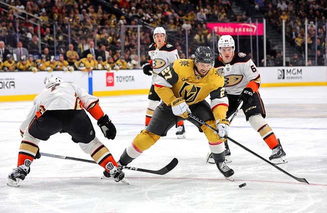 Vegas Golden Knights defenseman Shea Theodore (27) skates between Anaheim Ducks defenseman Radko Gudas (7) and right wing Sam Colangelo (64) during the third period of an NHL hockey game at T-Mobile Arena Thursday, April 18, 2024.
