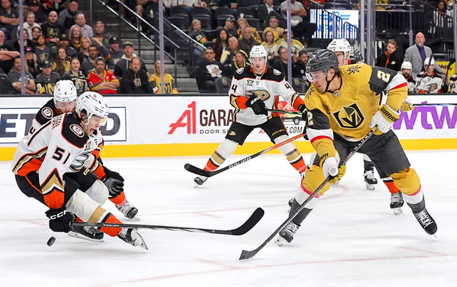 Anaheim Ducks defenseman Olen Zellweger (51) defends against Vegas Golden Knights defenseman Zach Whitecloud (2) during the third period of an NHL hockey game at T-Mobile Arena Thursday, April 18, 2024.