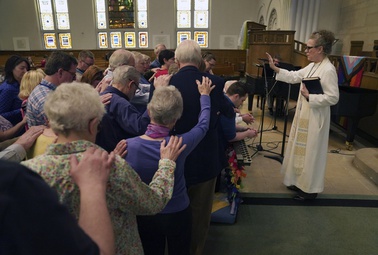 The Rev. Tracy Cox of First United Methodist Church and members of her congregation pray for Tracy Merrick, who will attend the United Methodist General Conference as a delegate representing Western Pennsylvania, as well as Anais Hussian and Joshua Popson who will also be in attendance, Sunday, April 14, 2024, in Pittsburgh.