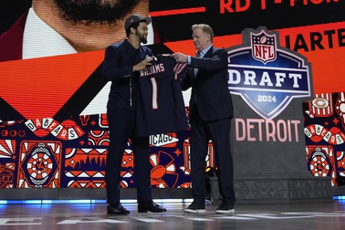 Southern California quarterback Caleb Williams celebrates with NFL commissioner Roger Goodell after being chosen by the Chicago Bears with the first overall pick during the first round of the NFL football draft, Thursday, April 25, 2024, in Detroit.

