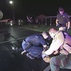 In this image from Altoona Police Department body-camera video, police restrain Demetrio Jackson in a parking lot on the border of Altoona and Eau Claire, Wis., on Oct. 8, 2021, minutes before a paramedic injects him with ketamine. Five medical experts who reviewed the case for AP said Jackson’s behavior did not appear to be dangerous enough to justify the use of ketamine.