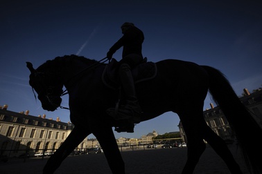 A horsewoman trains with her horse in the main courtyard of the royal stables, in Versailles, Thursday, April 25, 2024. 