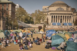 People listen to a speaker at a pro-Palestinian encampment, advocating for financial disclosure and divestment from all companies tied to Israel and calling for a permanent cease-fire in Gaza, inside the campus of Columbia University, Sunday, April 28, 2024, in New York.