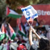 Veronica Gelfman waves Israeli and American flags to counterprotest a pro-Palestinian rally on UNLV’s campus Wednesday, May 1, 2024.