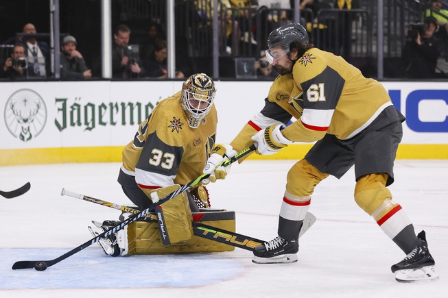 Vegas Golden Knights right wing Mark Stone (61) saves the puck from going into the net as Vegas Golden Knights goaltender Adin Hill (33) watches during the second period of Game 6 of an NHL hockey Stanley Cup first-round playoff series at T-Mobile Arena Friday, May 3, 2024.
