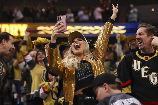 A Vegas Golden Knights fan celebrates during the third period of Game 6 of an NHL hockey Stanley Cup first-round playoff series against the Dallas Stars at T-Mobile Arena Friday, May 3, 2024.