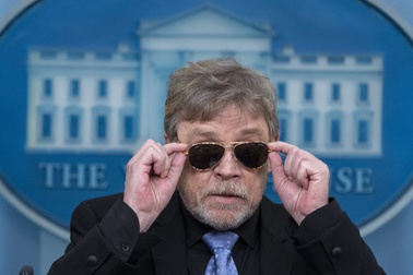 Actor Mark Hamill takes off sunglasses given to him by President Joe Biden, as he joins White House press secretary Karine Jean-Pierre as she speaks with reporters in the James Brady Press Briefing Room at the White House, Friday, May 3, 2024, in Washington.