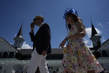 Race fans walk though the grounds of Churchill Downs before the 150th running of the Kentucky Derby horse race Saturday, May 4, 2024, in Louisville, Ky. 