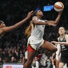 Las Vegas Aces' Jackie Young (0) drives past New York Liberty's Jonquel Jones (35) and Breanna Stewart (30) during the second half in Game 4 of a WNBA basketball final playoff series Wednesday, Oct. 18, 2023, in New York.