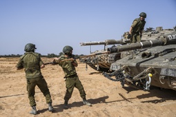Israeli soldiers work on a tank at a staging ground near the border with the Gaza Strip, in southern Israel, Sunday, May 5, 2024. 

