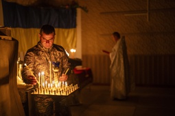An Ukrainian serviceman of the 72nd Separate Mechanized Brigade, lights candles during a Christian Orthodox Easter religious service, in Donetsk region, Ukraine, Saturday, May 4, 2024. 

