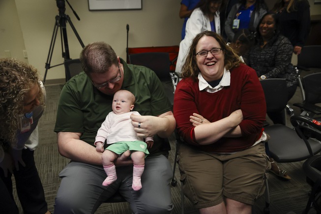 Three-month-old Johanna Spellacy is held by her father Brandon Spellacy as her mother Jesica Spellacy laughs during a press conference at the UMC Trauma Center Tuesday, May 7, 2024. Johanna’s life was saved on Feb. 7 when Las Vegas Fire & Rescue paramedics relieved constriction to her umbilical cord when she wasn’t getting enough oxygen during a breech birth.