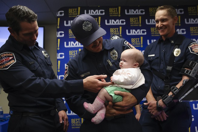 Three-month-old Johanna Spellacy is held by Las Vegas Fire & Rescue paramedic Chaisson Low during a press conference at the UMC Trauma Center Tuesday, May 7, 2024. Johanna’s life was saved on Feb. 7 when Las Vegas Fire & Rescue paramedics relieved constriction to her umbilical cord when she wasn’t getting enough oxygen during a breech birth.