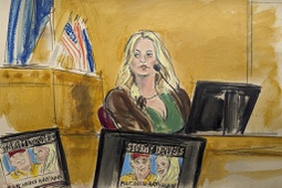 Stormy Daniels testifies on the witness stand as a promotional image for one of her shows featuring an image of Trump is displayed on monitors in Manhattan criminal court, Thursday, May 9, 2024, in New York.