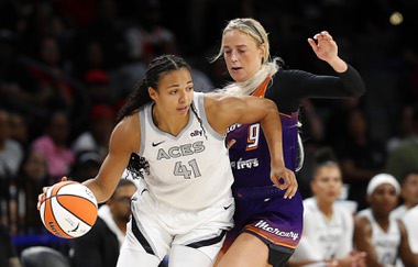 Las Vegas Aces center Kiah Stokes (41) takes the ball past Phoenix Mercury guard Sophie Cunningham (9) during the first half of an WNBA basketball game at Michelob Ultra Arena in Mandalay Bay Tuesday, May 14, 2024.