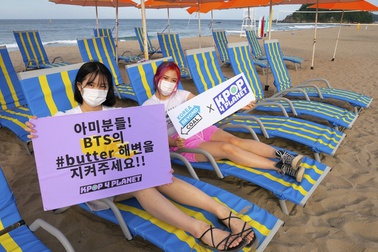 In this image provided by Kpop4Planet, demonstrators pose at Maengbang Beach in Samcheok, South Korea, as part of the #SaveButterBeach campaign in September 2021.