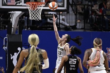 Indiana Fever guard Caitlin Clark (22) scores her first basket against the Connecticut Sun during the second quarter of a WNBA basketball game, Tuesday, May 14, 2024, in Uncasville, Conn. 


