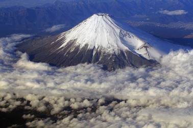 In this Dec. 8, 2010 file photo, snow-covered Mount Fuji, Japan's highest peak at 3,776-meters tall (12,385 feet), is seen from an airplane window. Those who want to climb one of the most popular trails of the iconic Japanese Mount Fuji will now have to reserve ahead and pay a fee as the picturesque stratovolcano struggles with overtourism, littering and those who attempt rushed “bullet climbing,” putting lives at risk. 


