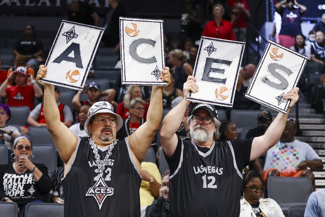 Las Vegas Aces fans hold signs during the first half of a WNBA basketball game against the New York Liberty Saturday, June 15, 2024, in Las Vegas.