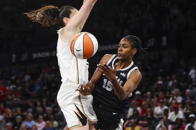 Las Vegas Aces guard Tiffany Hayes (15) passes the ball against New York Liberty forward Breanna Stewart (30) during the first half of a WNBA basketball game Saturday, June 15, 2024, in Las Vegas.