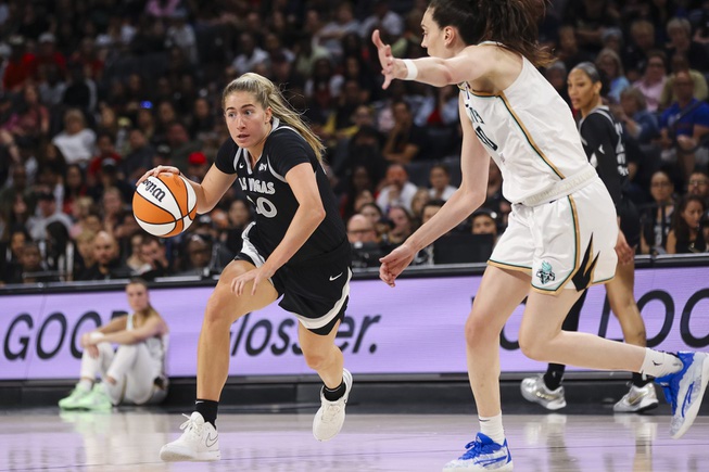 Las Vegas Aces guard Kate Martin (20) moves the ball against New York Liberty forward Breanna Stewart (30) during the first half of a WNBA basketball game Saturday, June 15, 2024, in Las Vegas.