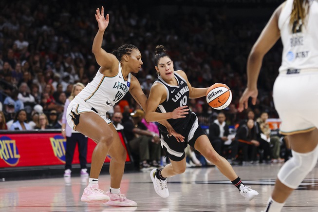 Las Vegas Aces guard Kelsey Plum (10) handles the ball against New York Liberty forward Betnijah Laney-Hamilton (44) during the second half of a WNBA basketball game Saturday, June 15, 2024, in Las Vegas.