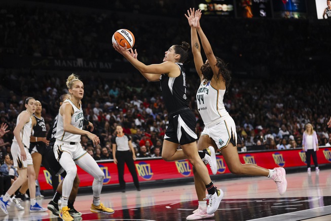 Las Vegas Aces guard Kelsey Plum (10) goes for a lay up against New York Liberty forward Betnijah Laney-Hamilton (44) during the second half of a WNBA basketball game Saturday, June 15, 2024, in Las Vegas.