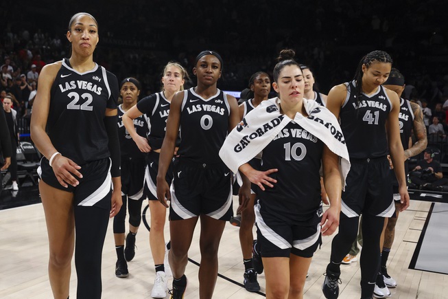 The Las Vegas Aces stand on the court after losing to New York Liberty, 90-82, during the second half of a WNBA basketball game Saturday, June 15, 2024, in Las Vegas.