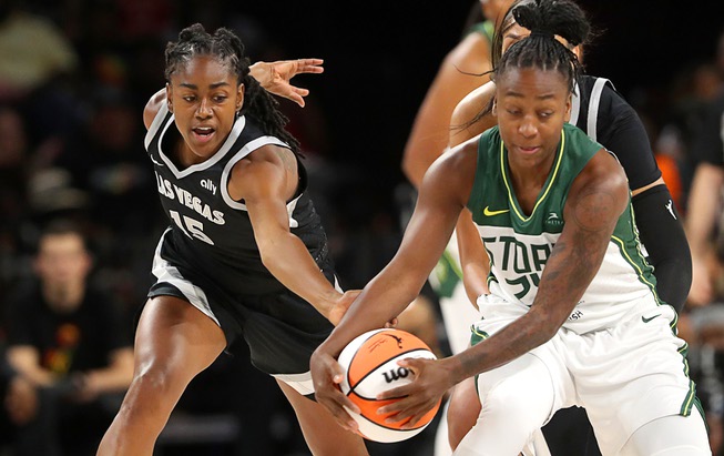 Las Vegas Aces guard Tiffany Hayes (15) and Seattle Storm guard Jewell Loyd (24) fight for the ball during the first half of an WNBA basketball game at Michelob Ultra Arena in Mandalay Bay Wednesday, June 19, 2024, in Las Vegas.