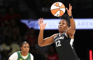 Las Vegas Aces guard Chelsea Gray (12) reaches for a loose ball during the first half of an WNBA basketball game against the Seattle Storm at Michelob Ultra Arena in Mandalay Bay Wednesday, June 19, 2024. 