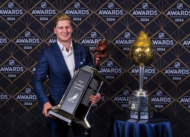 Colorado Avalanche forward Nathan MacKinnon stands with his trophies as the recipient of the Hart Memorial Trophy, left, and Ted Lindsay Award at hockey's NHL Awards, Thursday, June 27, 2024, in Las Vegas.


