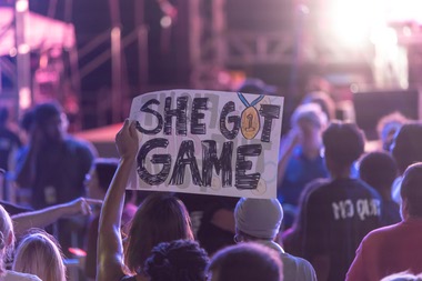 Olympic athletes hit Park MGM to a wall of noise — fans and passersby alike, decked in Team USA gear, shook glittering red and blue pom-poms and waved hand-painted signs to welcome them in.